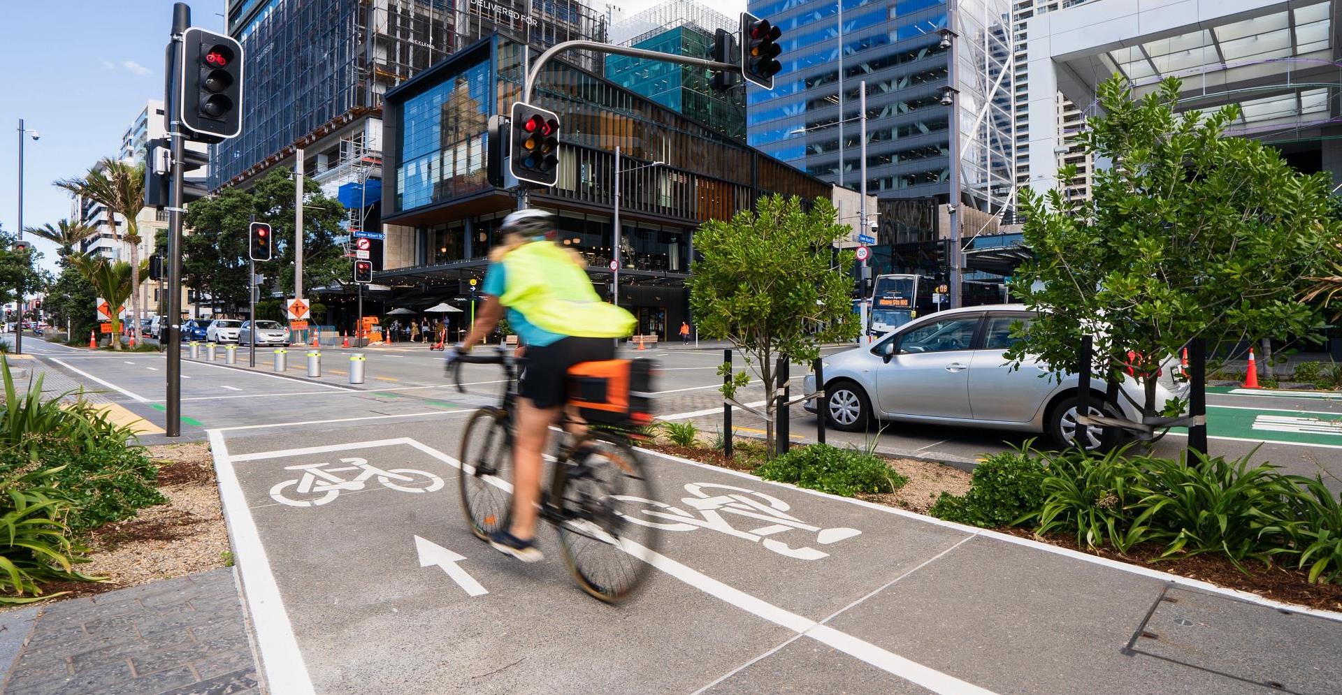 Traffic, divided way for cars and bicycle in city.
