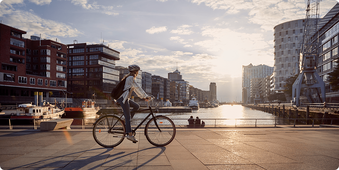 An individual pedaling a bike on a sunny day, surrounded by nature and showcasing the joy of cycling.