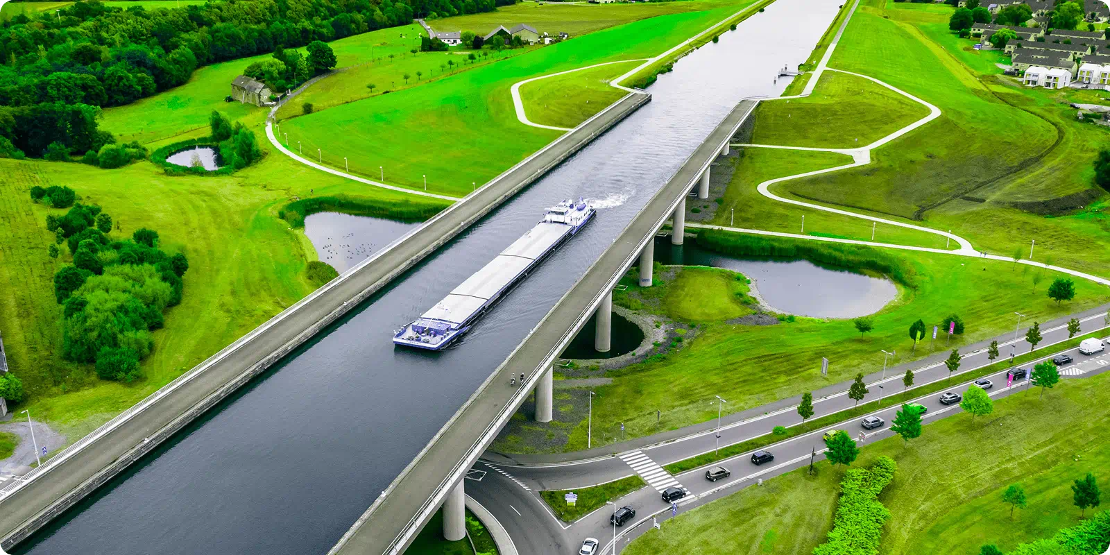 Aerial view of a large bridge spanning a river, showcasing its structure and the surrounding landscape.