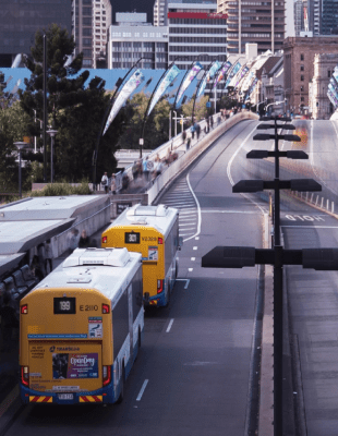 Image of a city street featuring buses in bus stations.