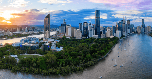 Brisbane, Australia skyline: a vibrant cityscape with modern skyscrapers, set against a backdrop of blue skies and the Brisbane River.