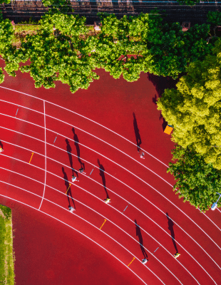 Aerial view of a running track with people jogging on it.