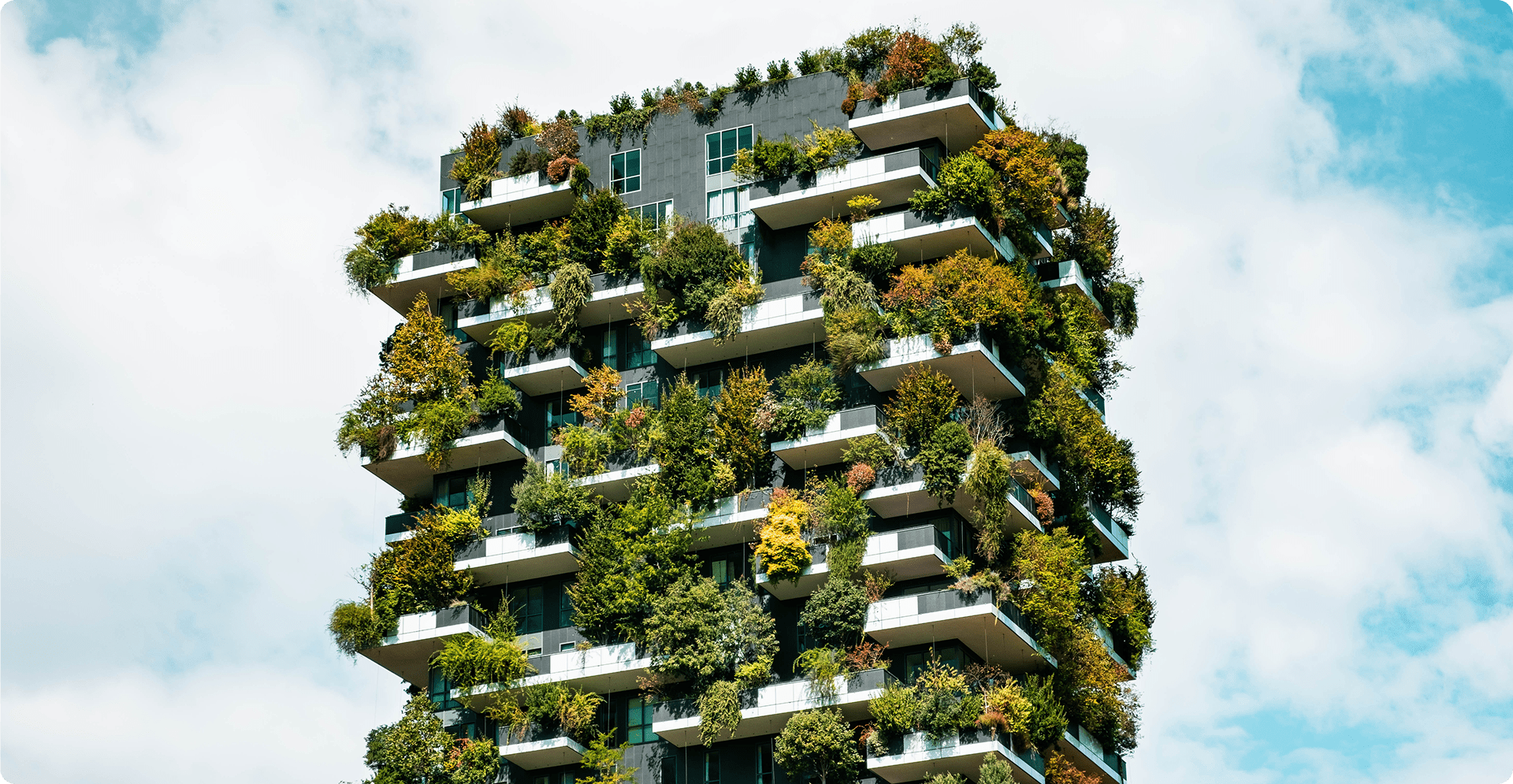 Green residential tower with lush balcony gardens and modern architecture.