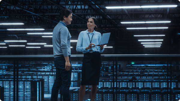 Man and woman having conversation in data center.