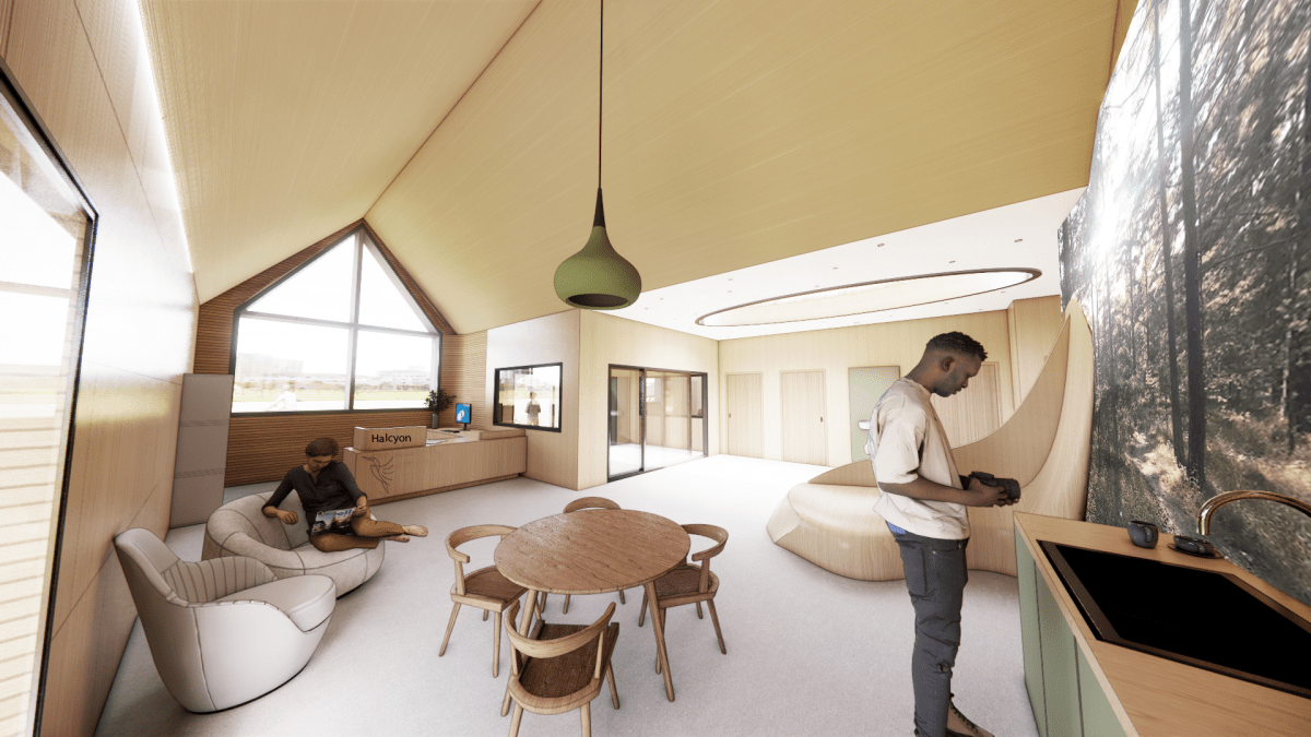 A room that includes a kitchen and a couch, highlighting a comfortable living space.