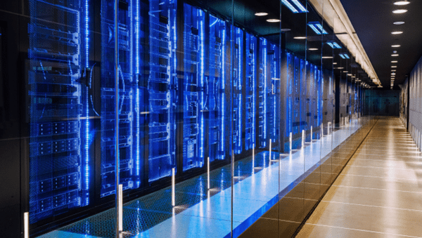 Sustainable Data Centers A long hallway with rows of servers in a data center, providing secure storage and processing capabilities.