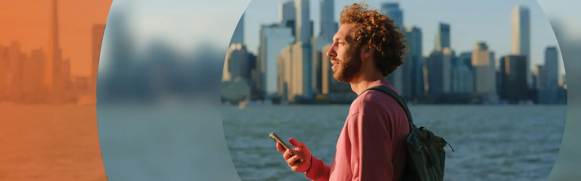 A man with a backpack stands by a tranquil body of water, gazing at the serene landscape before him.