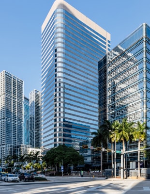 A skyline view of modern office buildings in Miami, showcasing sleek architecture against a clear blue sky.