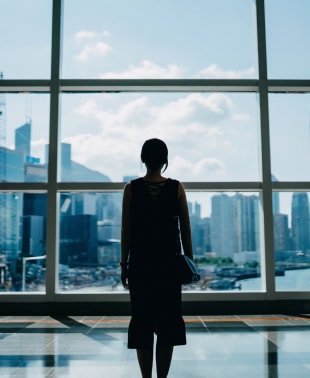 Woman looking at the overlooking scenery inside the building