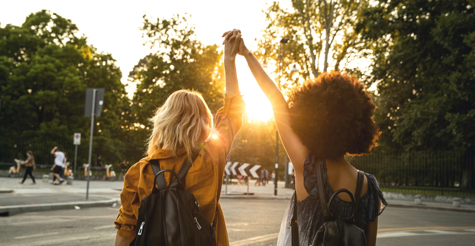 Girls walking, holding hands above their heads