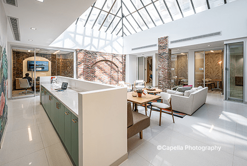 A bright kitchen and dining room featuring a skylight that illuminates the space with natural light.