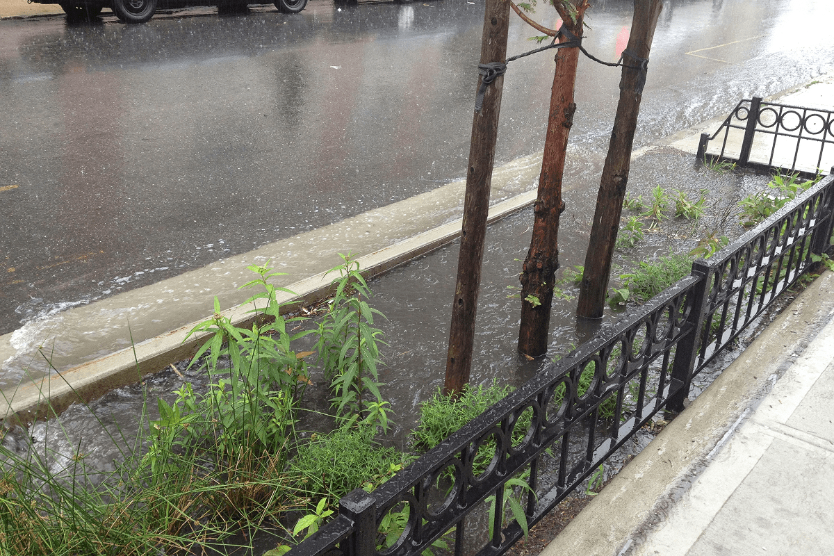 A street scene features a running water fountain, providing a serene focal point amidst the urban environment.