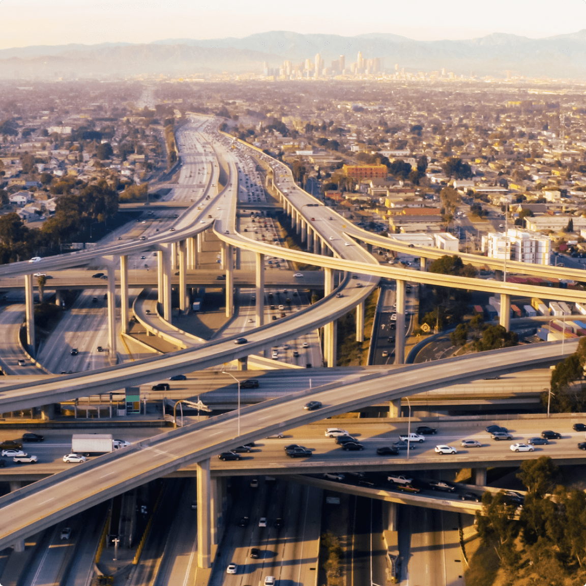 Aerial view of a busy freeway filled with numerous cars, showcasing the flow of traffic from above.