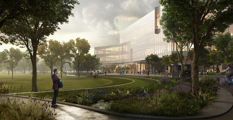 一名男子站在一栋建筑旁的公园里。