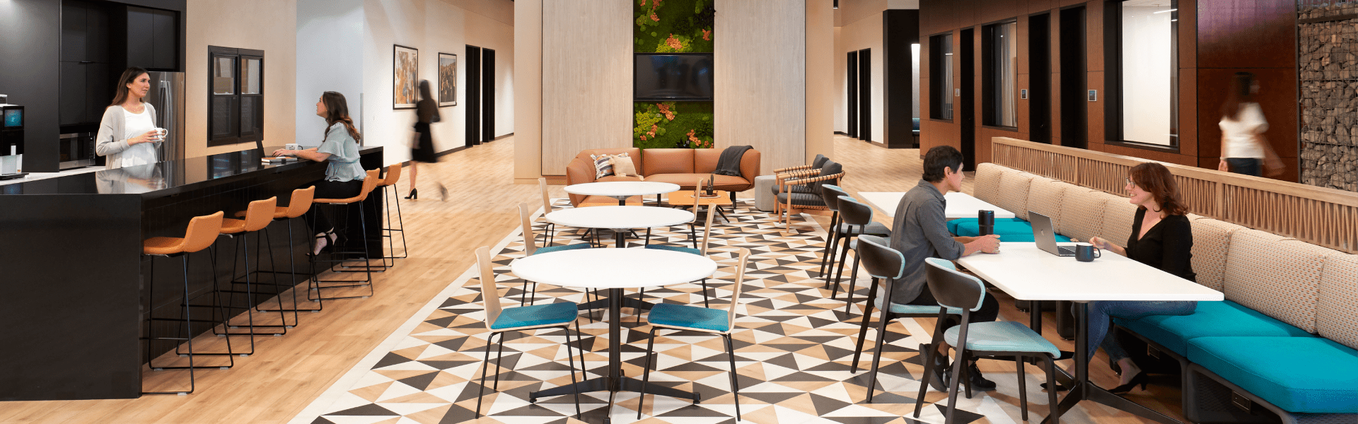 Spacious office lobby with large table and chairs.