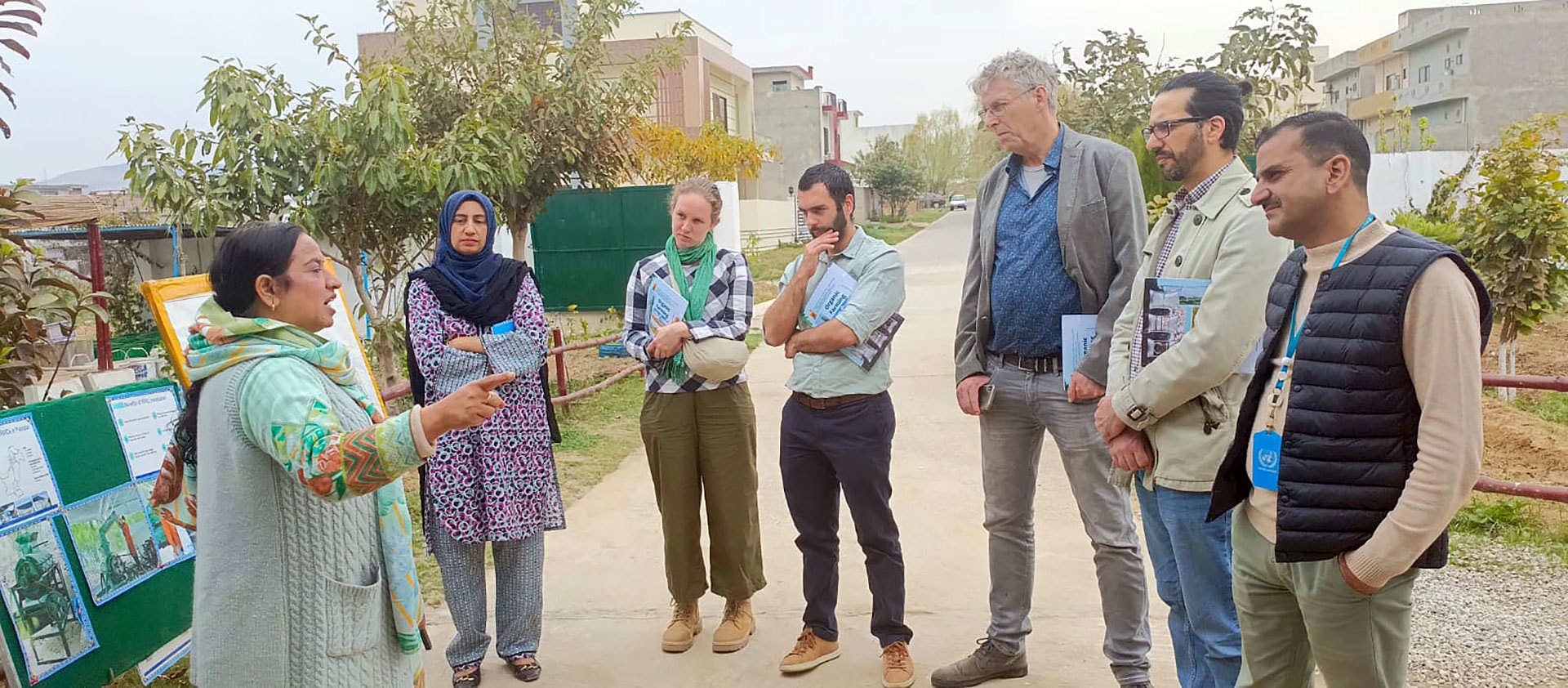 A group of people standing around each other.