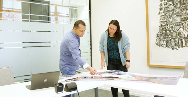 The Future Academy Two individuals collaborating in a office meeting room.