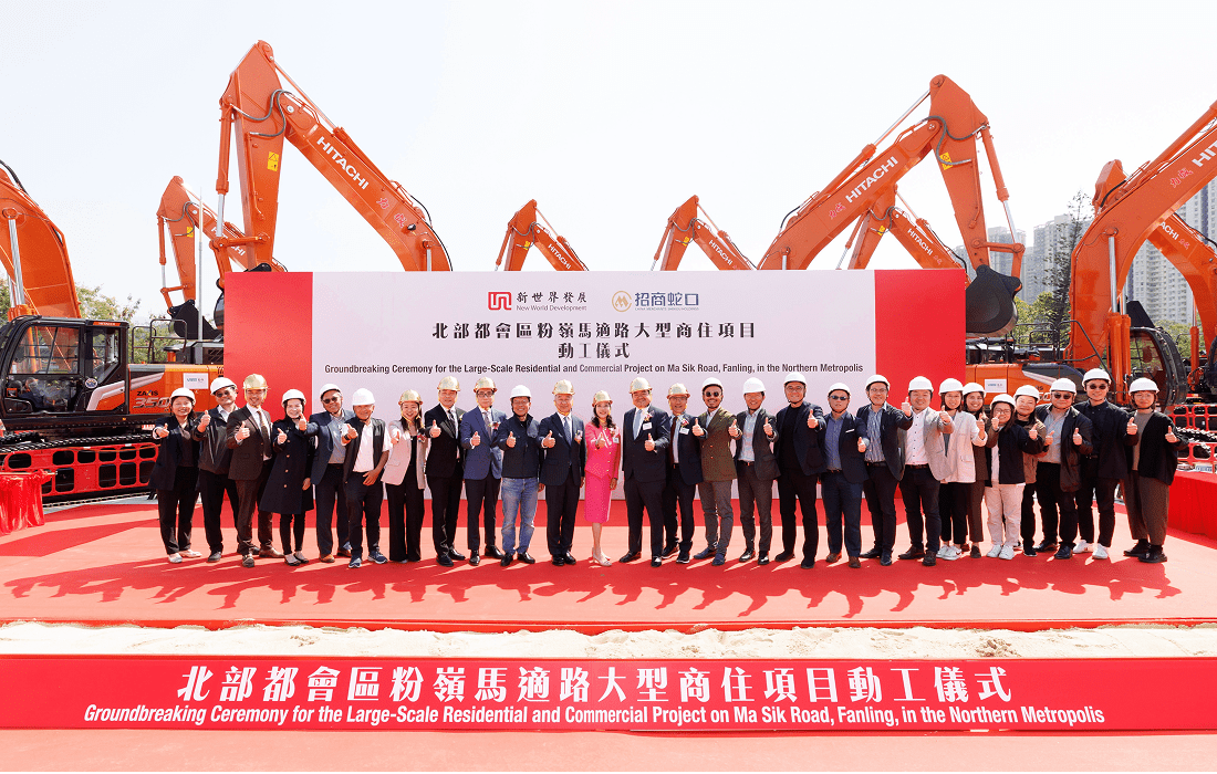 A diverse group of people stands before a large construction vehicle, examining its structure and discussing its purpose.
