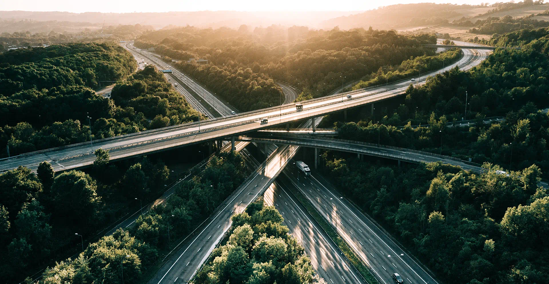  Aerial perspective of highway overpasses in a rural landscape, highlighting the blend of transportation and natural scenery.