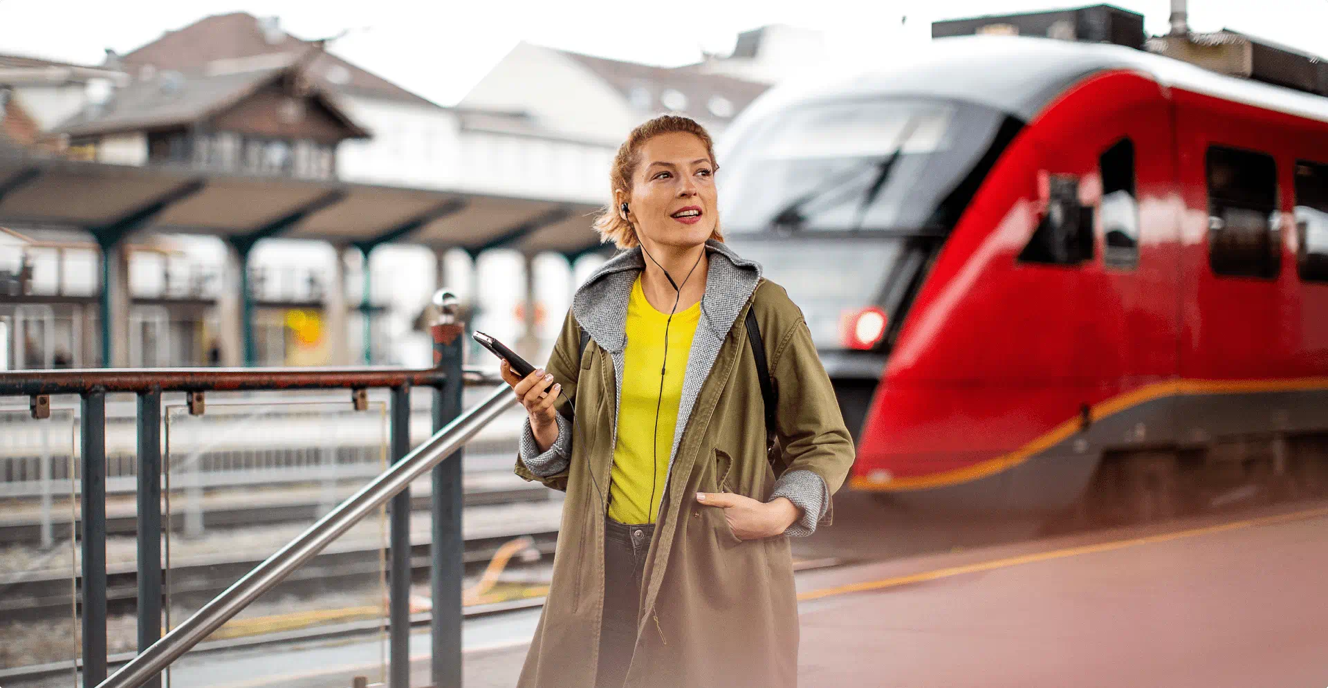 Woman waiting at a railroad station