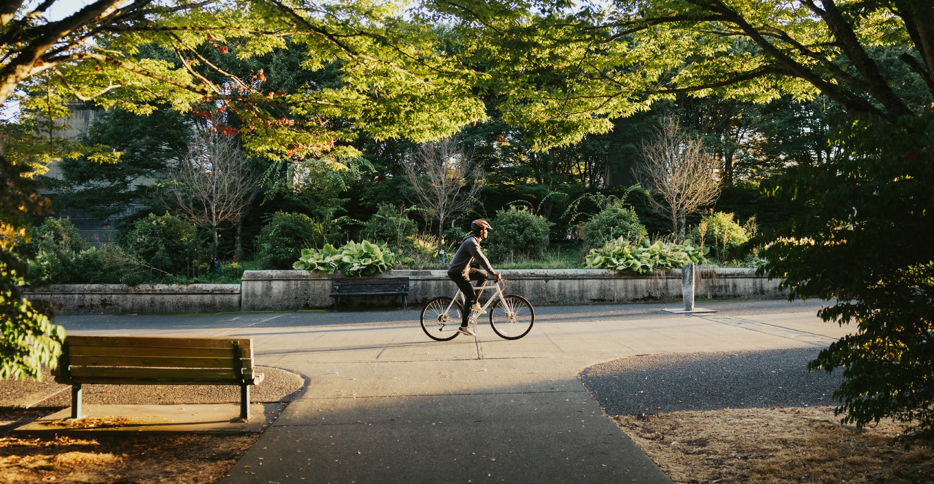 A person riding a bicycle along a scenic path, enjoying the outdoors and the freedom of cycling.