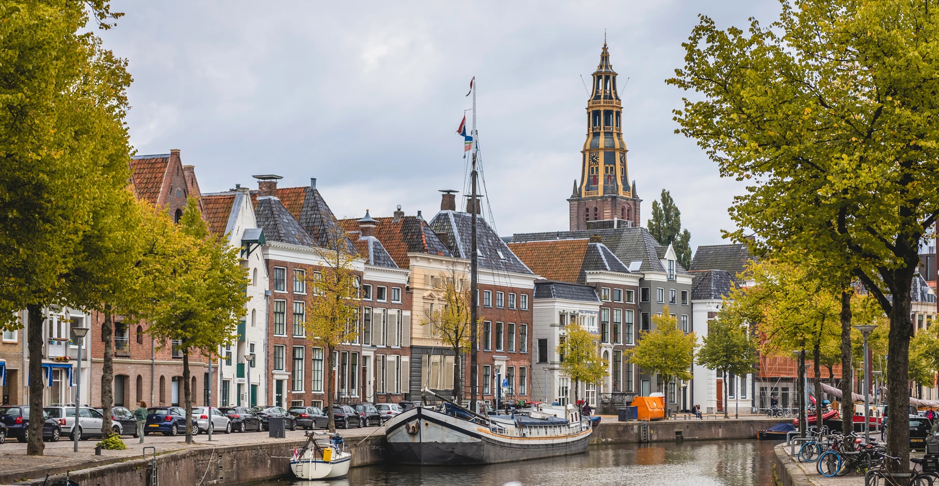 Netherlands, Groningen, City canal with row of townhouses in background
