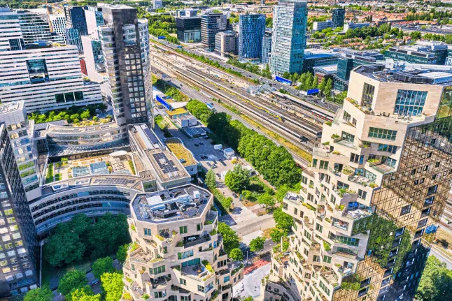 This aerial view showcases the modern skyline of the Zuidas financial district in Amsterdam, Netherlands.