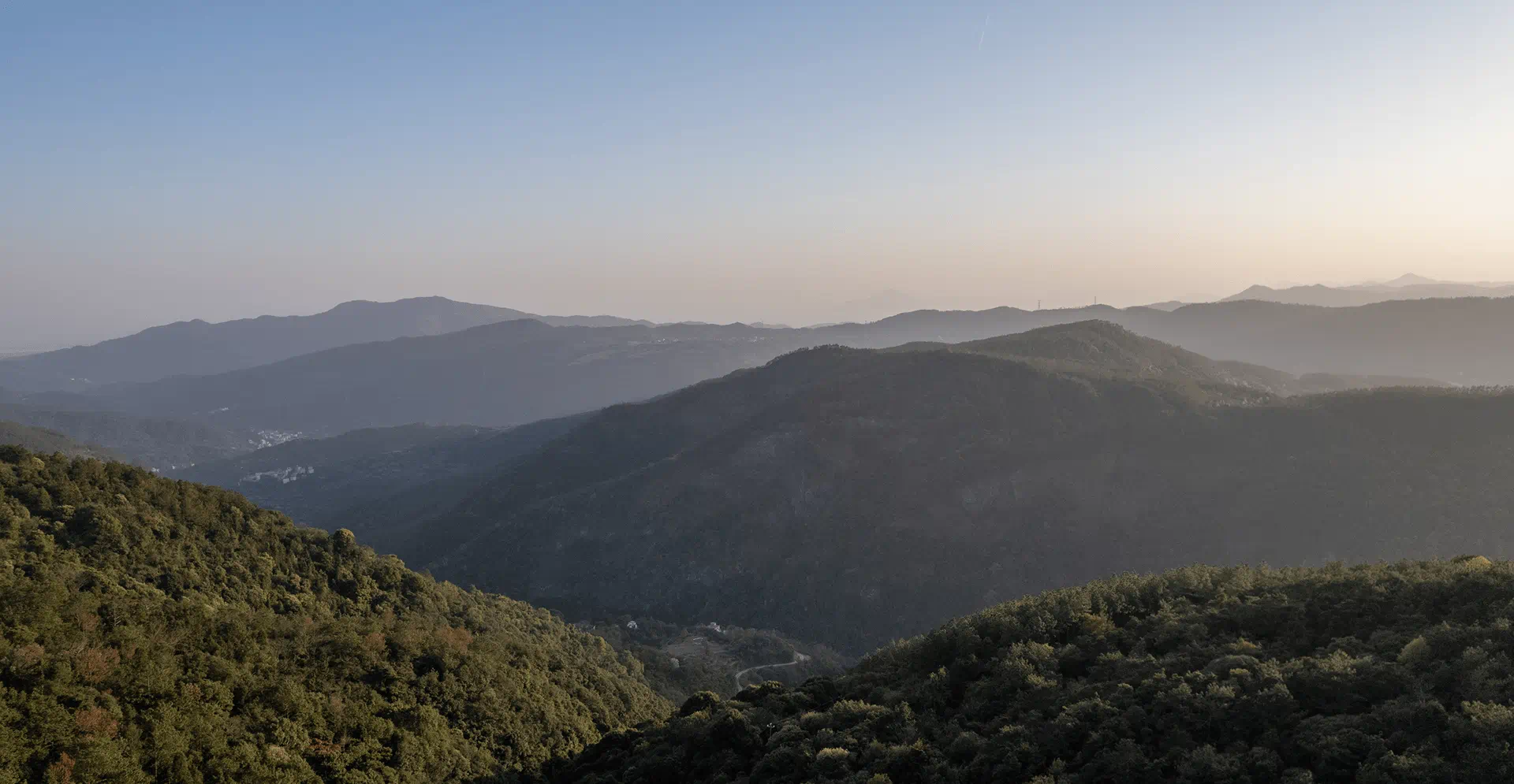A breathtaking view of distant mountains from a high point, emphasizing their grandeur and expansive surroundings