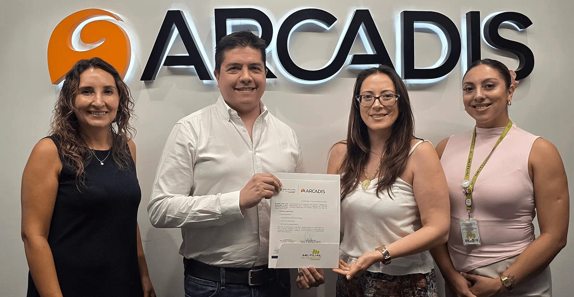 Four representatives conferring a certificate of achievement.