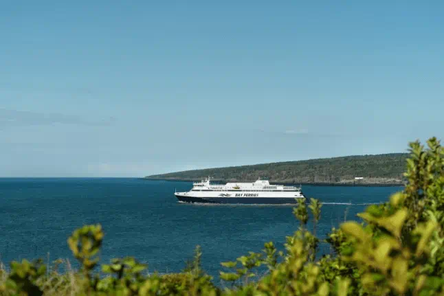 An image of the MV Fundy Rose passing by the Bay of Fundy.