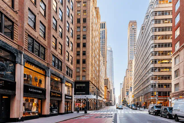 This image captures a wide-angle perspective of Fifth Avenue in Midtown Manhattan, New York City.