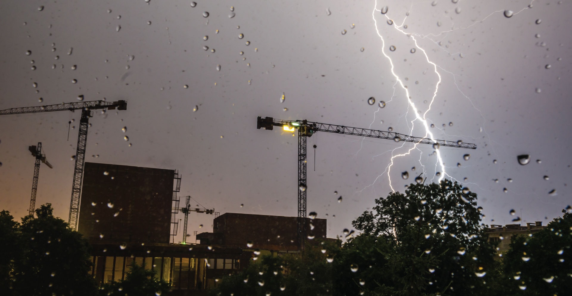 Construction site on a stormy night with lightning