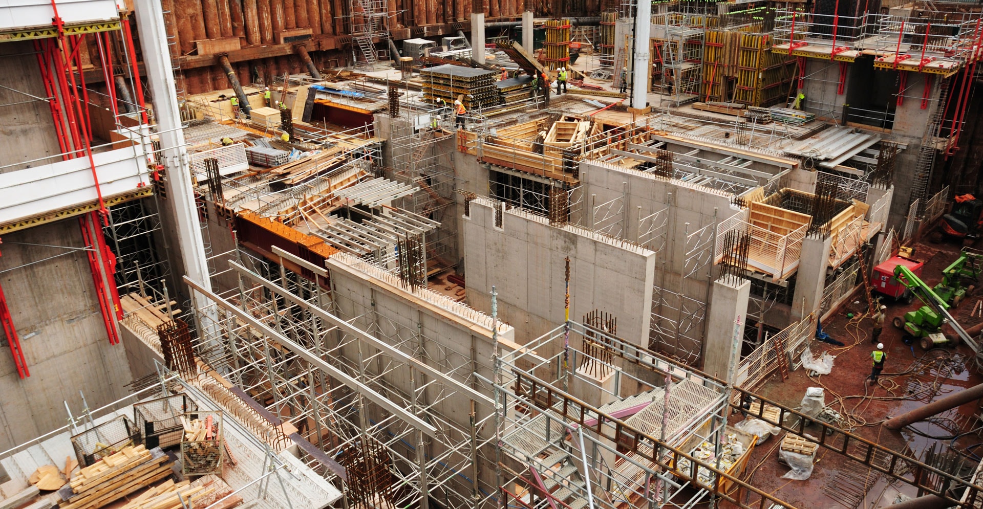 Construction workers are actively working on a building that is currently under construction.