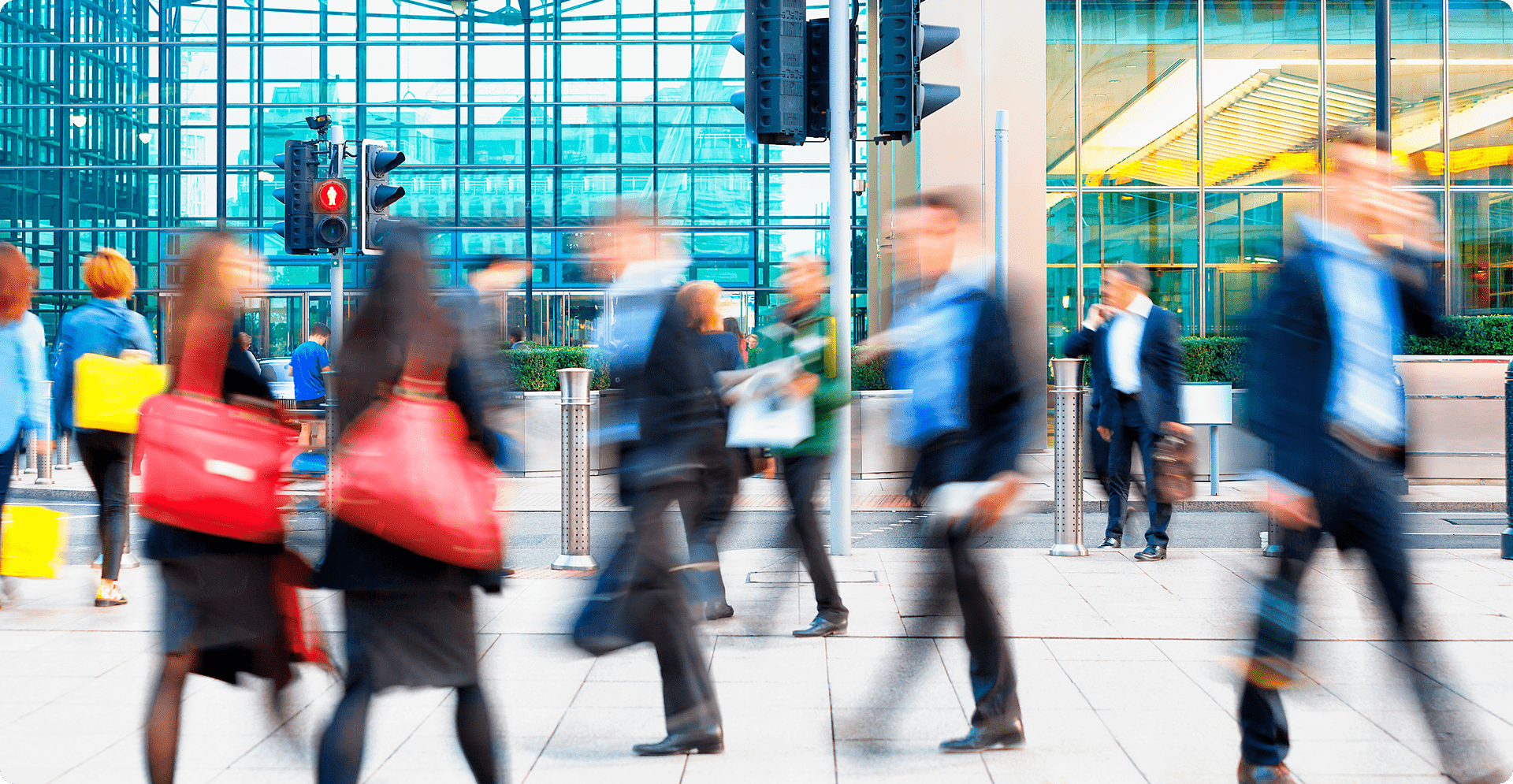 A hazy scene depicting individuals strolling in a city, surrounded by indistinct urban architecture.