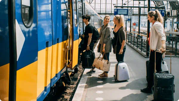 A group of friends getting on the train in Amsterdam