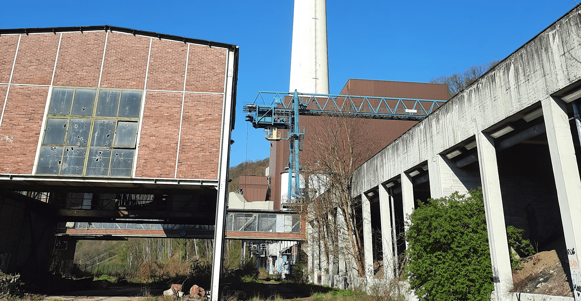 A building is framed by a clock tower in the background, showcasing a blend of historical architecture.