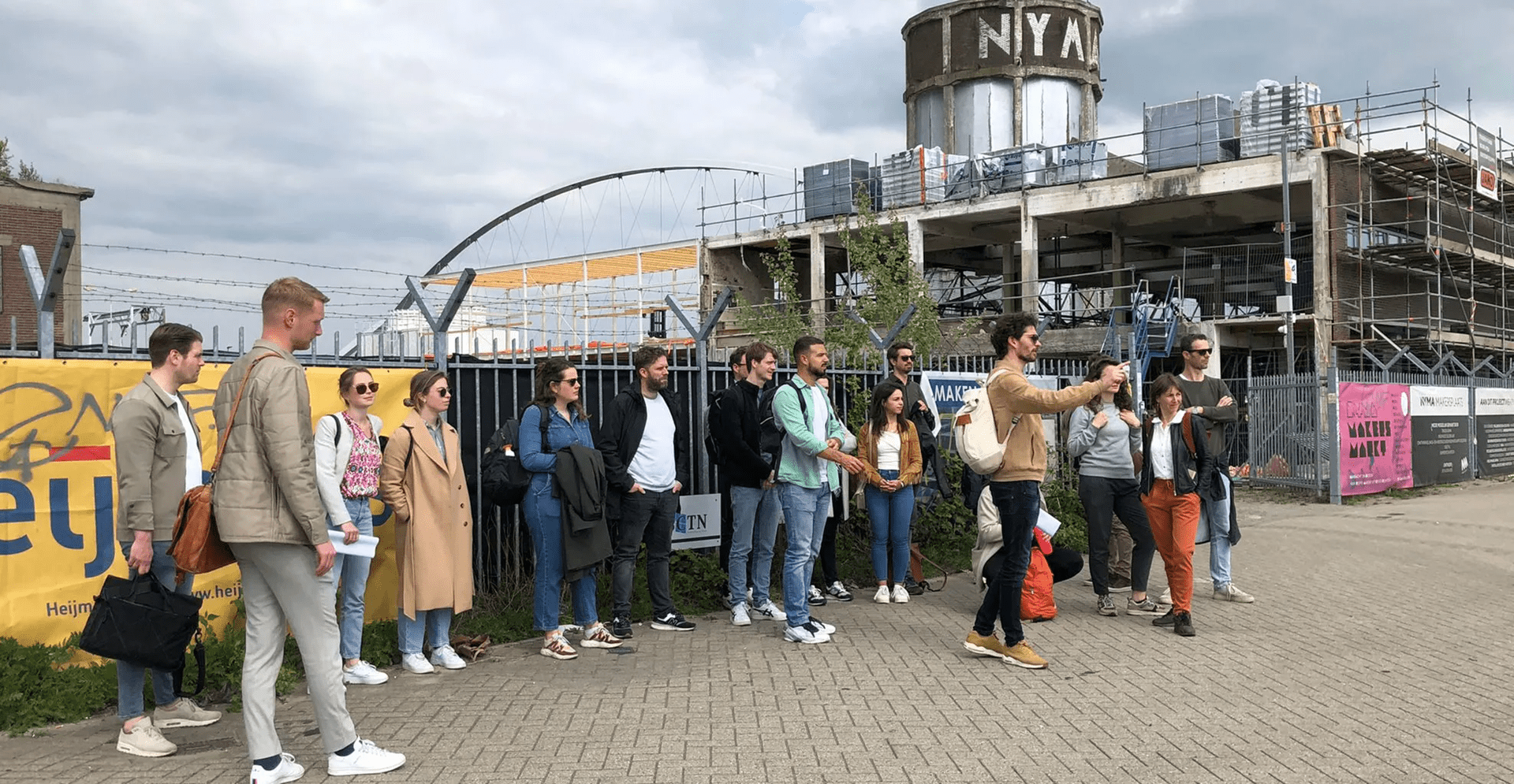 Crowd of people gathered outside a contemporary architectural landmark.
