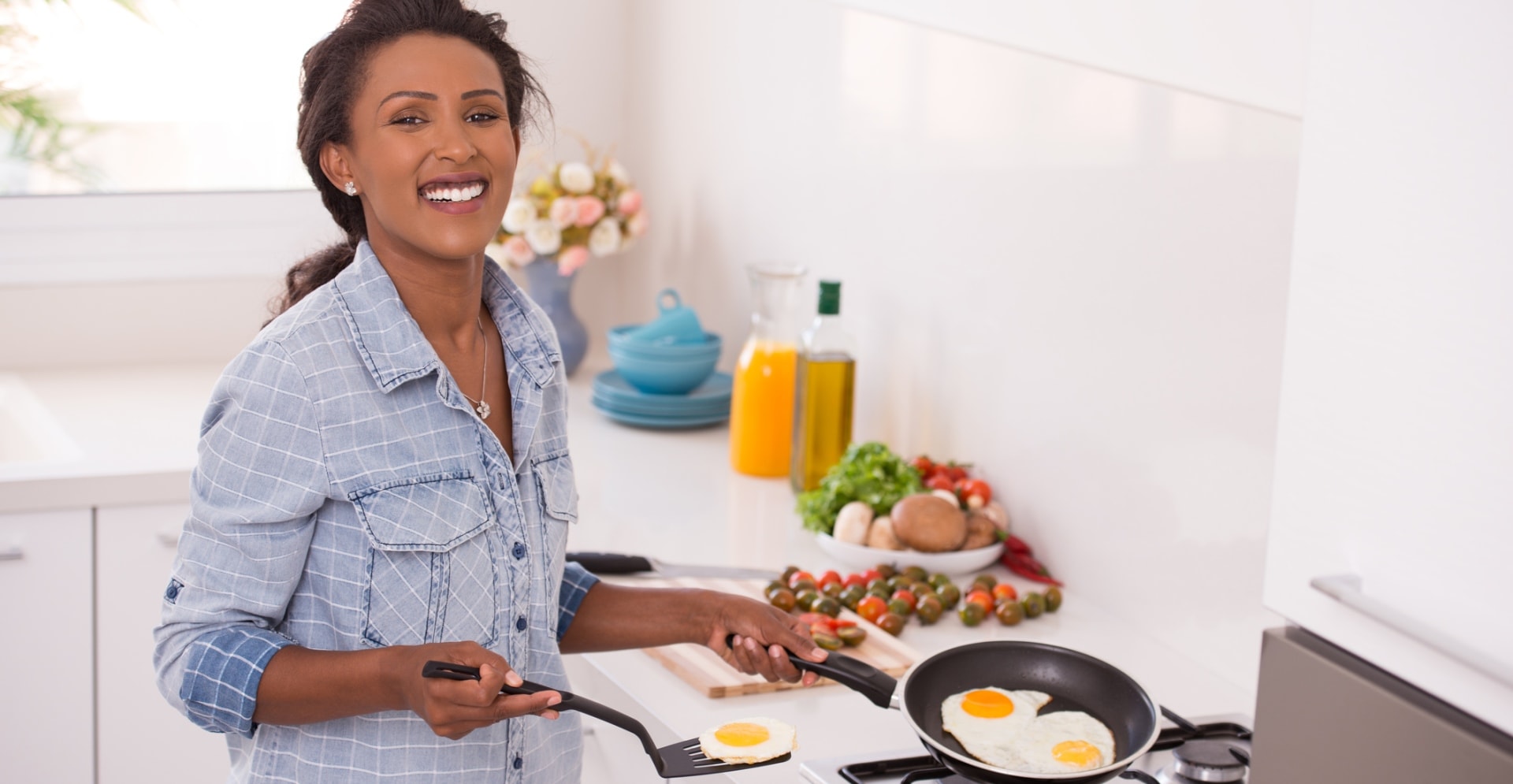 Vrouw die gebakken eieren in een pan maakt die mogelijk PFAS-houdend is.
