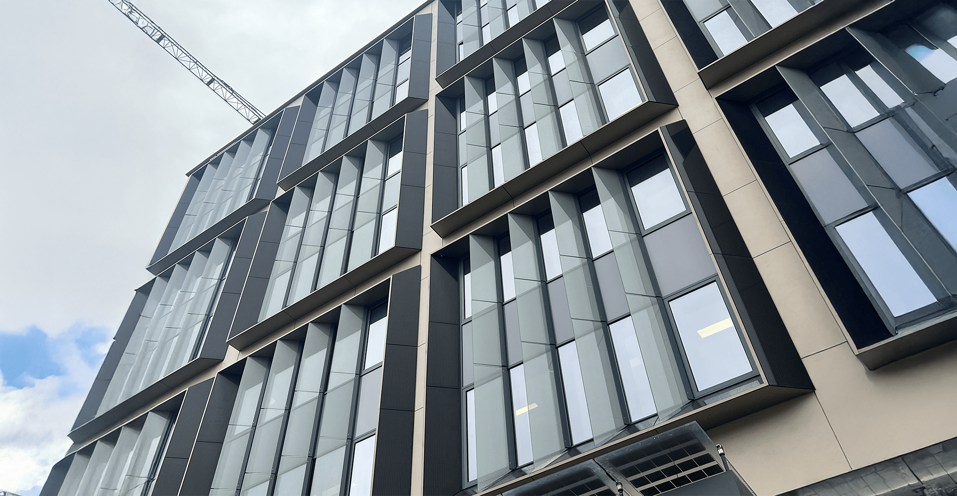 A building with a white van parked in front, showcasing a clear view of the structure and vehicle.