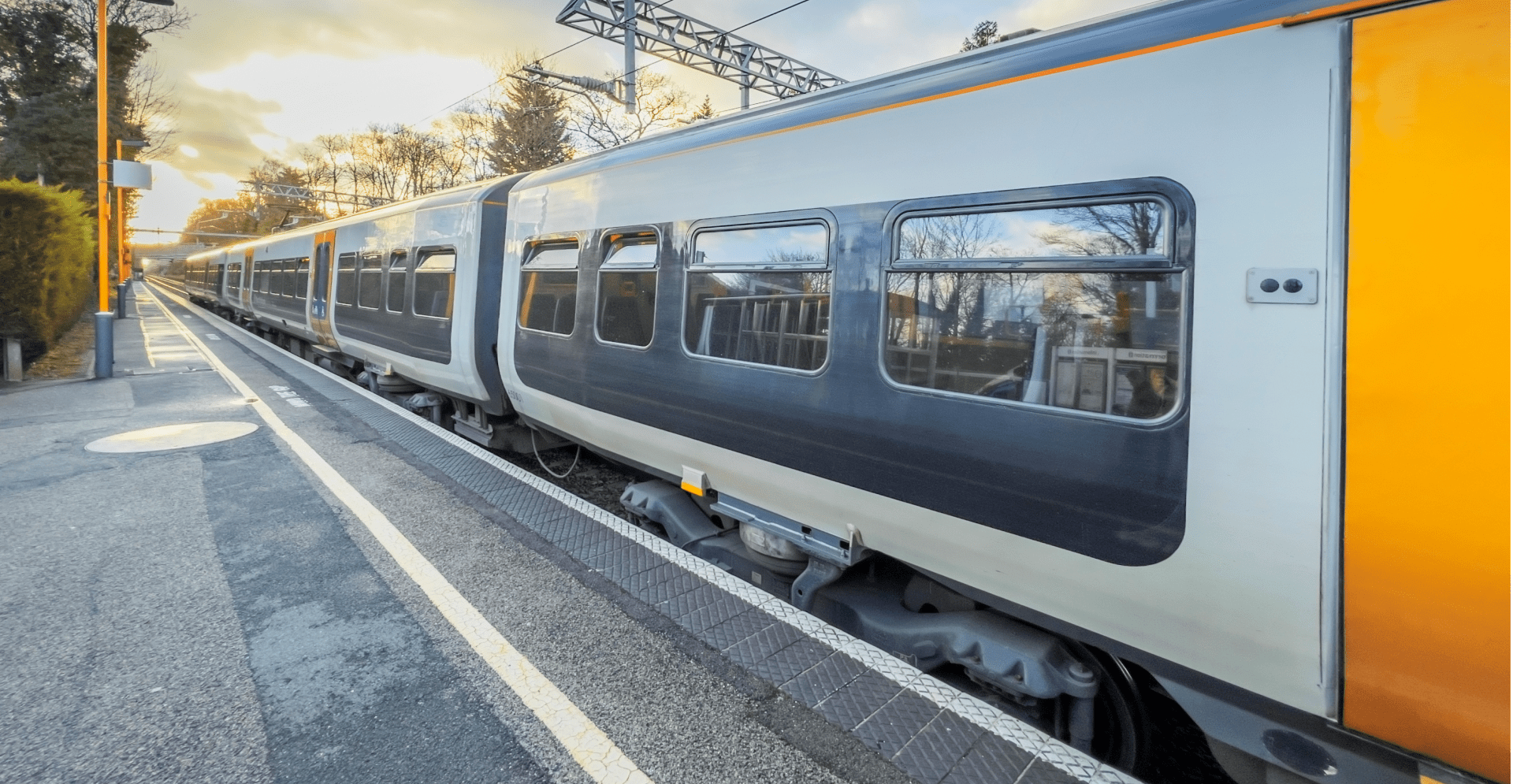 A train traveling on the tracks through a scenic countryside landscape.