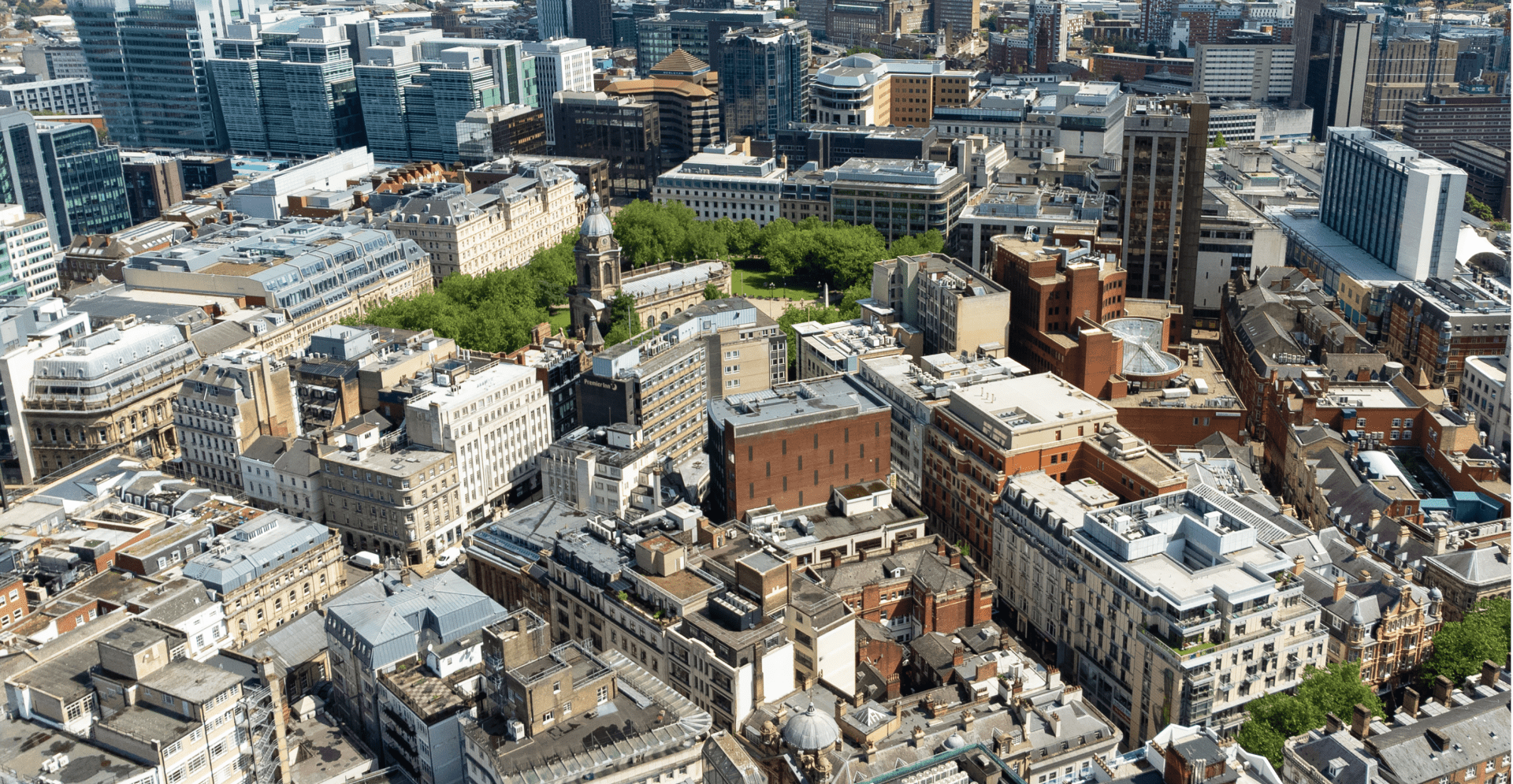 Aerial view of London cityscape from a building's rooftop, showcasing the urban landscape and iconic landmarks.