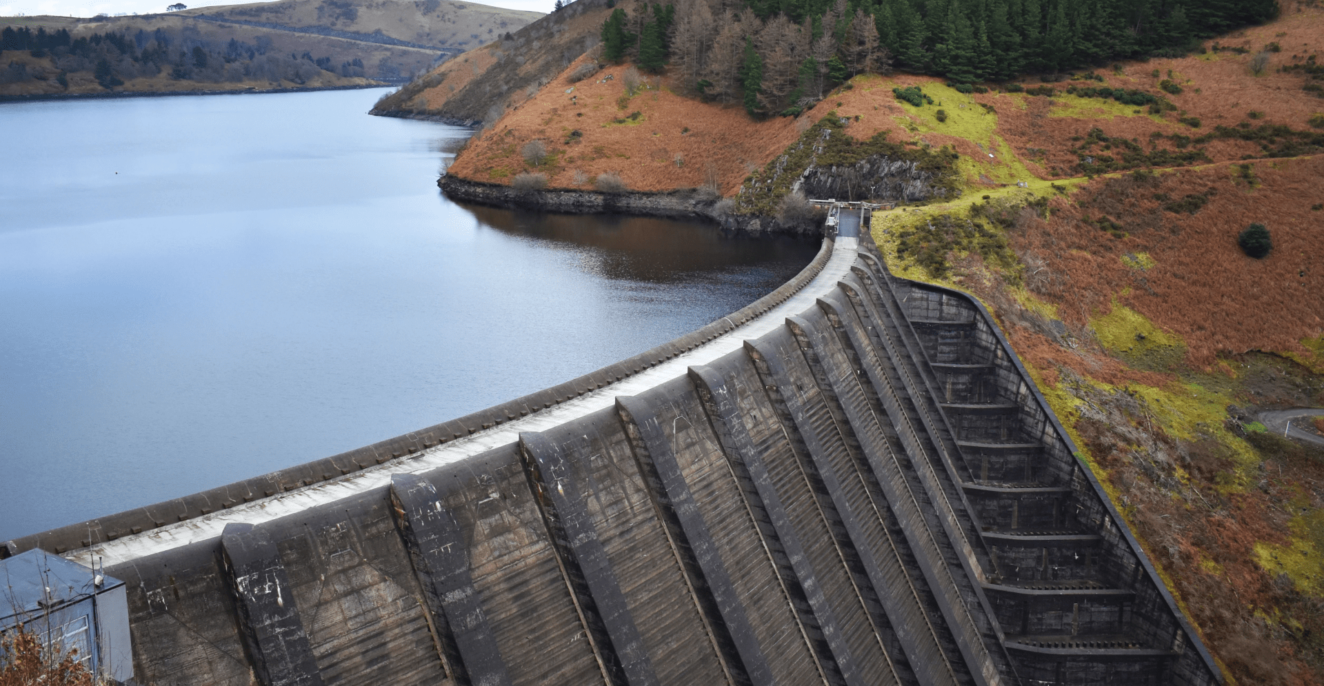 A massive dam with water cascading down, creating a powerful waterfall.
