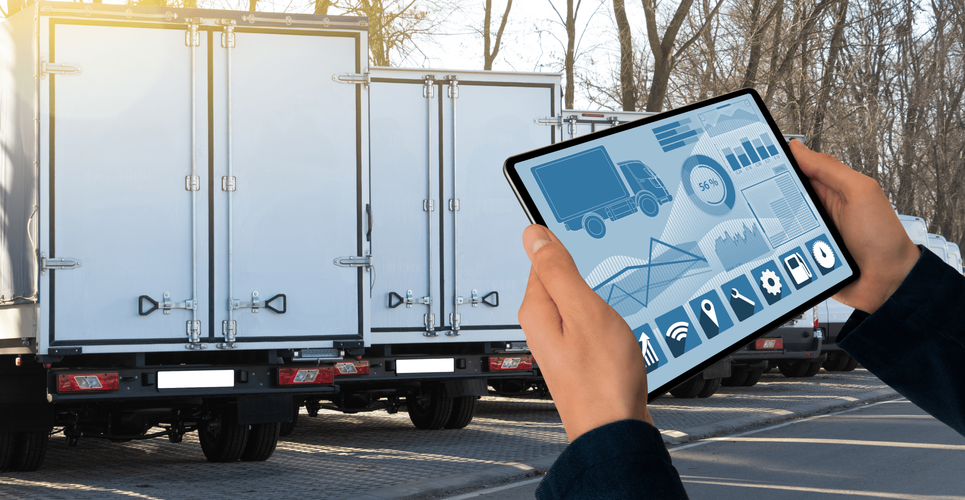 A person holding a tablet displaying a truck on the screen.