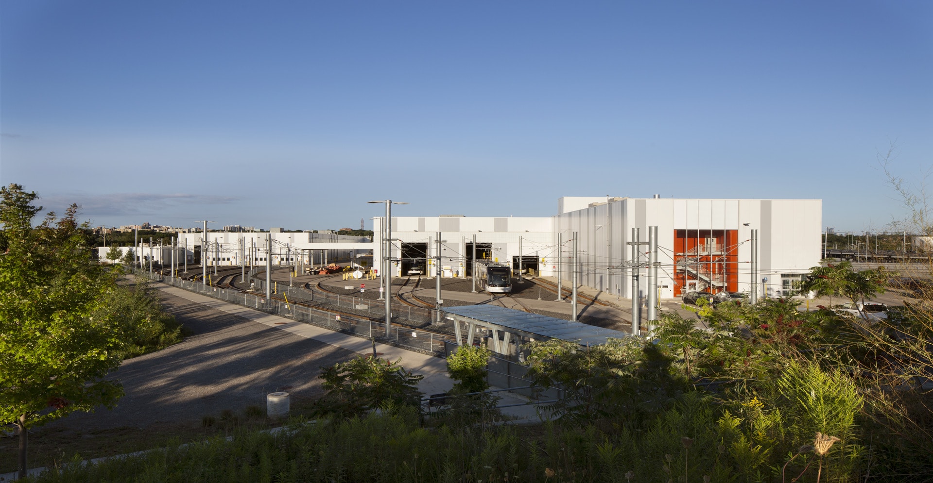 A large white building stands prominently next to a spacious parking lot.
