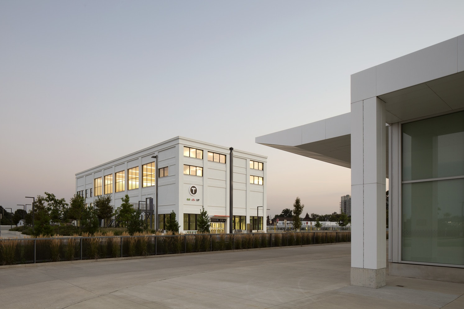 A building featuring white walls and a prominent large window.