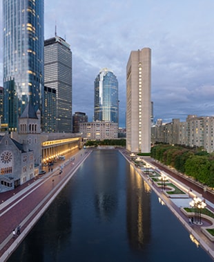 A vast expanse of water reflecting the sky, surrounded by distant landforms and a serene atmosphere.