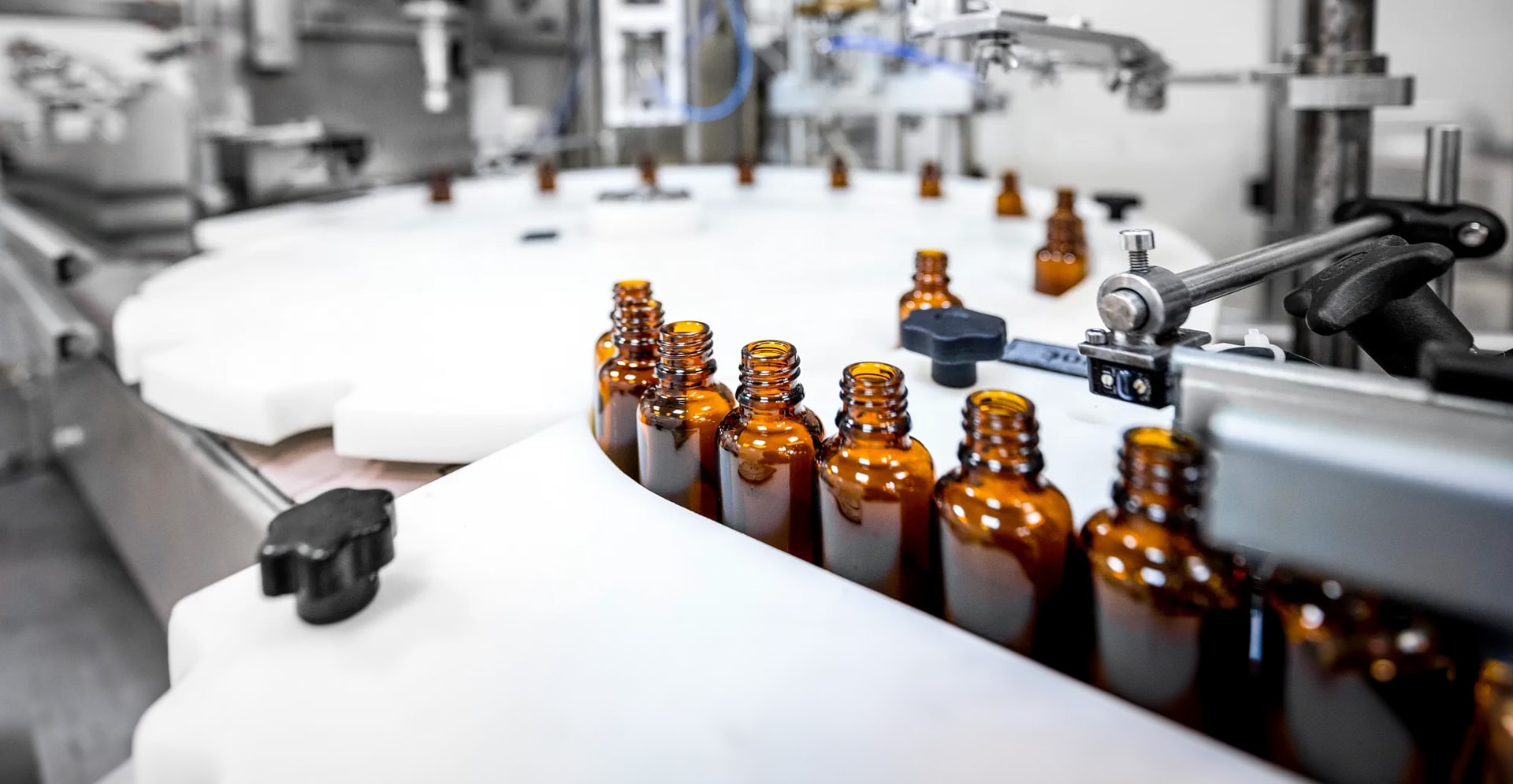 Focus on brown bottles perfectly arranged in a pharmaceutical laboratory