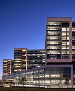 A large building featuring numerous windows, showcasing a modern architectural design and ample natural light.